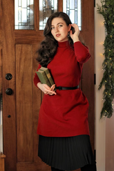 a lady in a red sweater dress with a belt